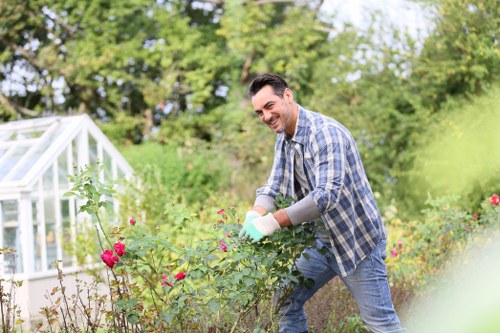 Volunteer planting seeds in a community garden in Deptford